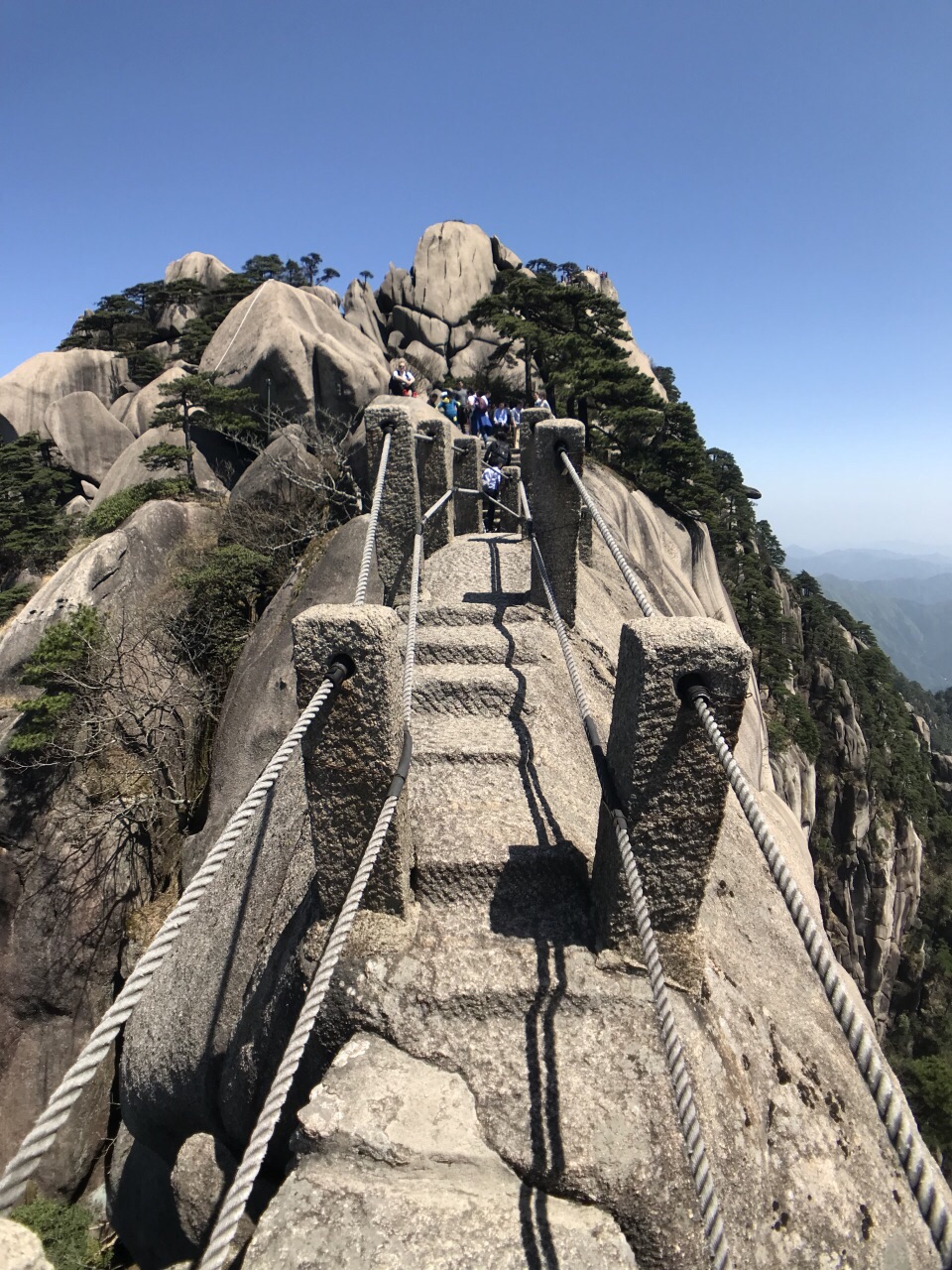 游玩天都峰选择了住玉屏楼。玉屏楼迎客松旁有条下山通道直通天都峰。一路上看到很多挑夫挑菜送上山很辛苦。从玉屏楼到天都峰全程大概四小时。上山的路不轻松陡直 路面也不是很宽。爬到鲫鱼背是顶峰。在鲫鱼背上行走要胆量。路面不宽才六十公分。两边悬崖绝壁。有雾的时候行走看不到下面还可以。没雾走在上面看下面要要有勇气。