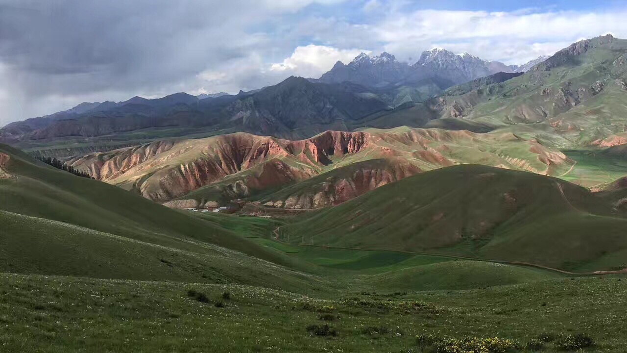 海拔4300米的卓尔山就在祁连县,登上山顶,远处连绵起伏的就是祁连山脉