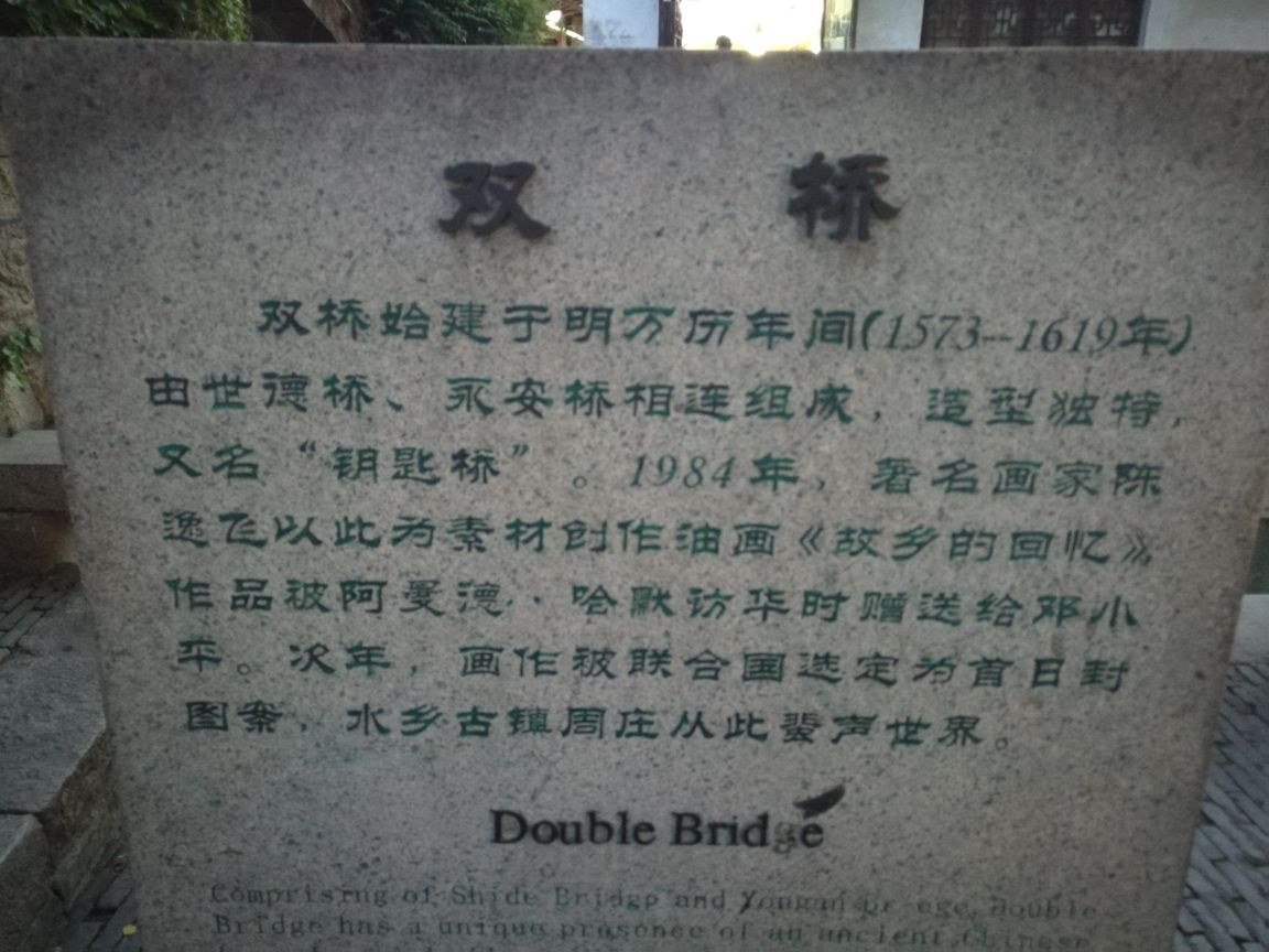 双桥是周庄标志性景点,也是周庄美景的精华地带,属于游客来周庄旅游必需打卡拍照的。所谓双桥,就是两座石拱桥垂直相连,上面爬满了绿色的植被,距今也有百年的历史了。双桥很小很窄,常常会被游人堵住。这里的水不是特别好,乘船会从桥下穿过。粉墙黛瓦和小桥流水构成的周庄,在船的穿梭下,给人一种安宁祥和的感觉。几十年前,著名画家陈逸飞在这里绘画周庄水乡风貌,一经展出,惊艳了外国人的朋友圈,因为这在世界上独一无二的。所以,你在周庄可以经常见到外国人,这已经是外国人必去的中国50个旅游目的地之一。
