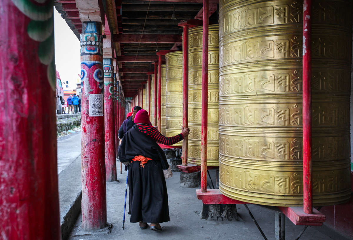 塔公寺的外围,一圈都是长长的转经筒走廊,绕寺一周相当于念了十三亿六