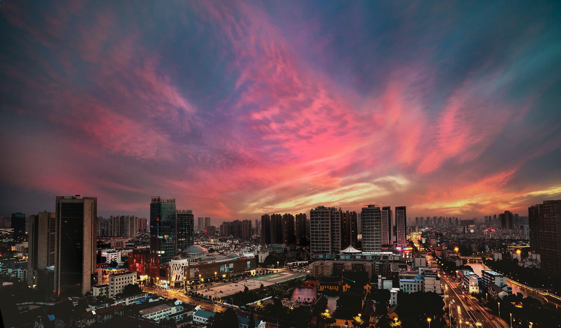 晚霞中的常州城,天空是静谧而厚重的深蓝,大地被镀上一层金色,水中的