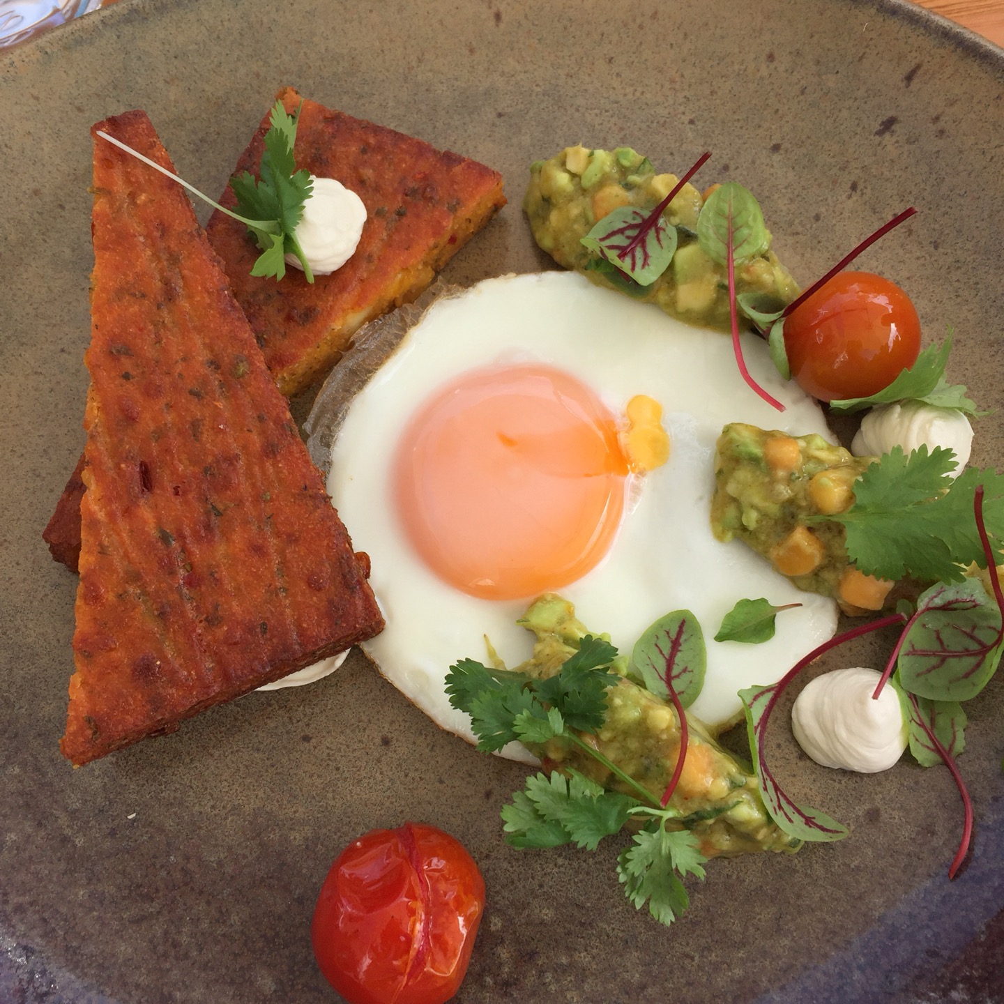 pave polenta labne cakes with avo corn salsa and fried egg